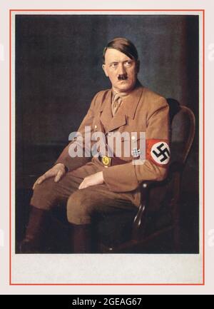 Vintage Adolf Hitler studio portrait formal seated in military uniform wearing a swastika armband Propaganda Election Poster Card 1930s Nazi Germany Stock Photo