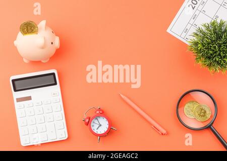 Piggy bank with calculators office desk top view. Stock Photo