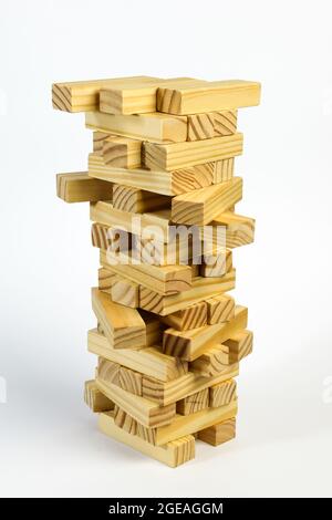 In the stack are many wooden children's blocks stacked on top of each other. Isolated on a white background in a mess. Stock Photo