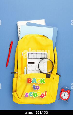 School backpack with stationery on the desk. Stock Photo