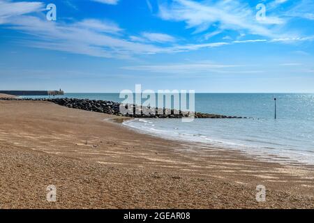 Folkestone Beach. The pebble beach is steeply inclined making for fast a change of tides. In this shot the tide is out and the sky is perfect. Stock Photo