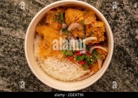 Delicious fried chicken with white rice or stream rice in the bucket.
