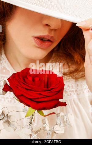 Woman in victorian clothing holding big red rose.  Party time Stock Photo