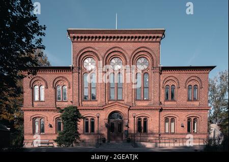Grand university building with red brick facade and big windows in Lund Sweden Stock Photo