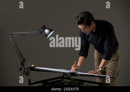 Chinese designer working on construction plan Stock Photo