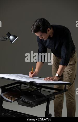 Chinese designer working on construction plan Stock Photo