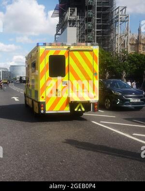 August 2021 - London yellow ambulance on a call out blue light run in Parliament Square. Stock Photo