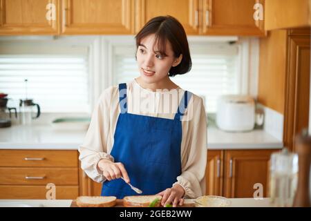 Japanese woman cooking at home Stock Photo