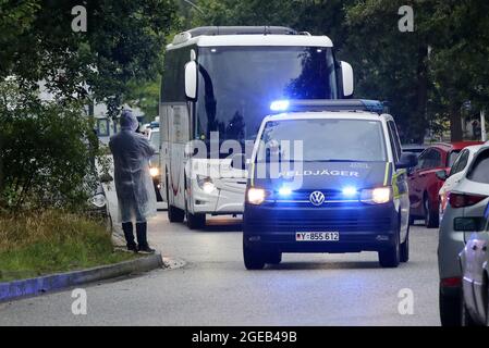 Hamburg, Germany. 18th Aug, 2021. Escorted by military police, a bus arrives from Frankfurt with people who had previously been evacuated from Afghanistan. The first local Afghan forces flown out of Kabul arrived at a reception facility in Hamburg in the early evening. Credit: Bodo Marks/dpa/Alamy Live News Stock Photo