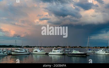 Rainclouds at sunset at Dolphin Marina.  Harpswell, Maine.  Orrs Island in background. Stock Photo