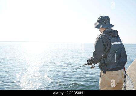 Japanese man fishing Stock Photo - Alamy