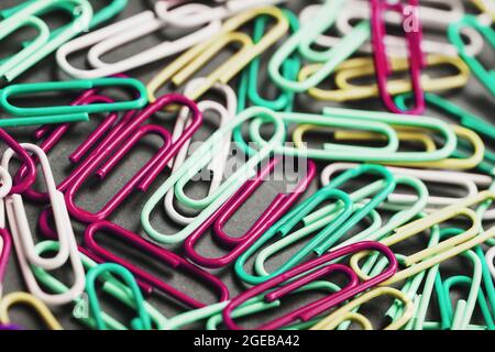 Colored paper clips textured background, full screen Stock Photo