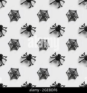 Halloween seamless pattern of black spiders and cobweb on gray background. Stock Photo