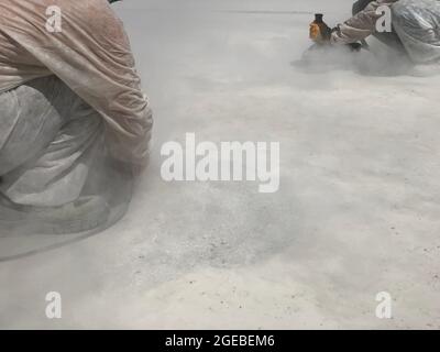 Construction workers are grinding concrete surface Stock Photo