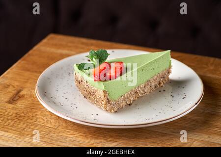 avocado lime cheesecake on a white wood background. toning. selective focus Stock Photo