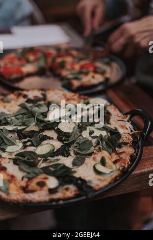 Couple of pizzas on pan Stock Photo