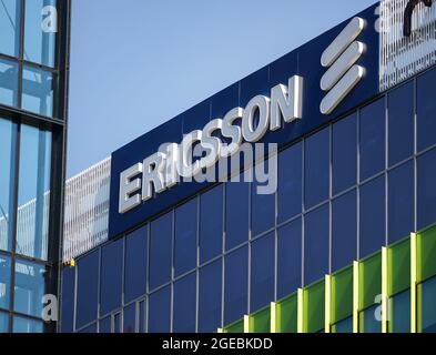 Bucharest, Romania - August 16, 2021: A logo of Ericsson, Swedish multinational networking and telecommunications company, is displayed above a buildi Stock Photo