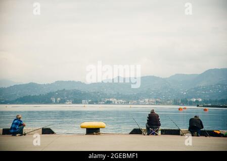 Batumi. Georgia - September 2020: Fishermen on the Black Sea coast in Batumi. High quality photo Stock Photo