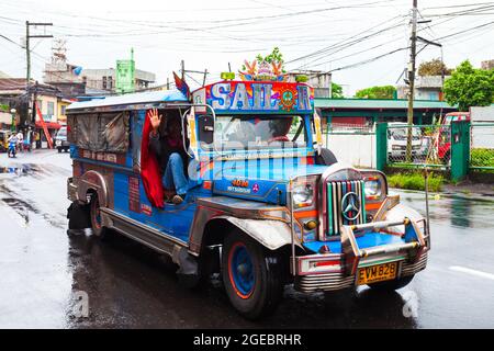 MANILA, PHILIPPINES - FEBRUARY 25, 2013: Jeepneys are popular public transport in the Philippines, they made from old US military jeeps Stock Photo