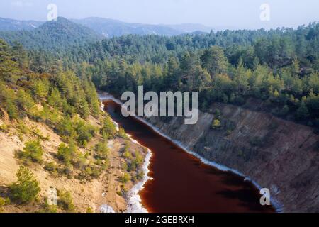 Acidic lake in abandoned open pit of copper mine in Paphos forest, Cyprus. Aerial landscape Stock Photo