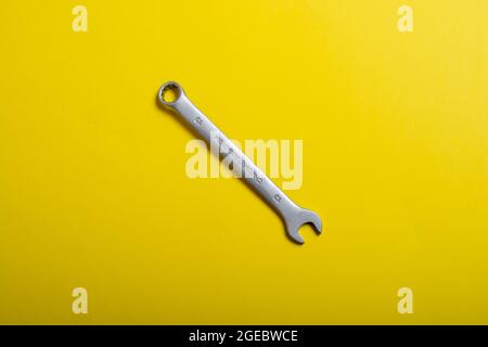 wrench on a yellow background Stock Photo