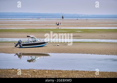 Maple Beach in Point Roberts USA. A boat beached on the sand at Boundary Bay at low tide in Point Roberts, Washington State, USA. Stock Photo