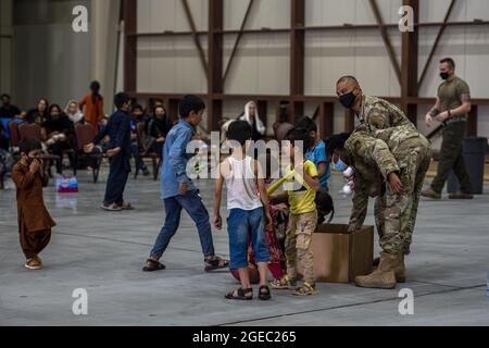 Al Udeid Air Base, Qatar. 18th Aug, 2021. Members of the 379th Air Expeditionary Wing distribute toys to Afghan citizens as part of Operation Allies Refuge, on August 16, 2021, at Al Udeid Air Base, Qatar. Photo by Airman 1st Class Kylie Barrow/U.S. Air Force/UPI Credit: UPI/Alamy Live News Stock Photo