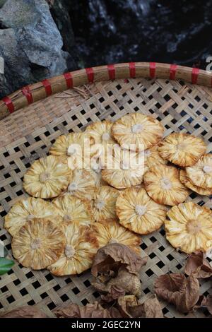 Dried pineapple layered  in organic food concept light yellow like the flowers in summer VietNam at a corner garden for eating snack, making cake Stock Photo
