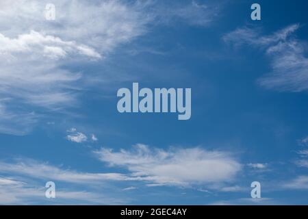 Beautiful cirrus clouds in the blue morning sky. Background of blue sky and white cirrus clouds in summer for your photos, mockup for design. Stock Photo