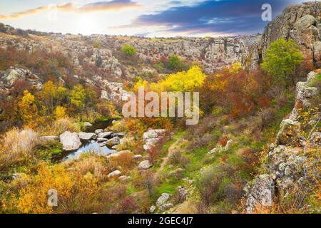 A small pile of stones in a green-yellow field against the background of sky in beautiful Ukraine Stock Photo