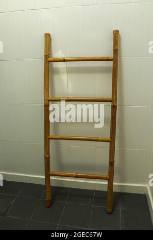 wooden towel hanger ladder bathroom on the gray floor Stock Photo
