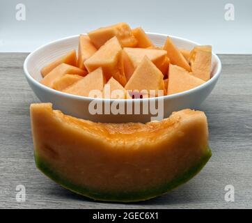 Pieces of refreshing Melon on wooden table. Fresh fruit Stock Photo