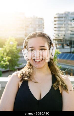 Portrait of happy sportive curvy woman with headphones after workout sesion Stock Photo