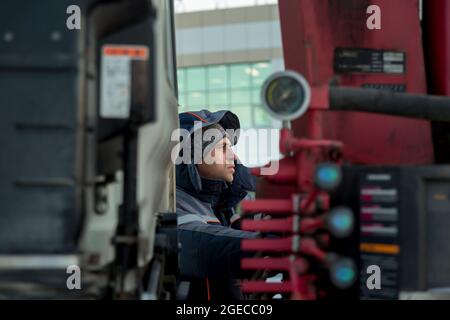 The driver of the hydraulic manipulator in the workplace Stock Photo