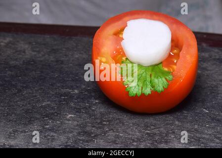 chopped tomato, radish and coriander decorated on the floor, selective focus, symbol of indian tricolor, happy republic day, happy independence day Stock Photo
