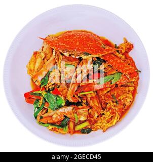 Delicious stir fried crab with eggs, vegetables, and curry powder on white background Stock Photo