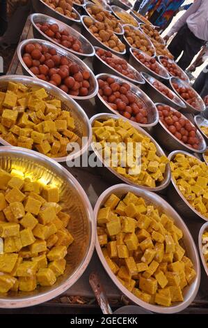 sweets for indian hindu marriage, gulab jamun, cashew katli and snacks placed in steel plate Stock Photo