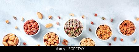 Nuts panoramic banner, overhead flat lay shot onn a slate background with a place for text Stock Photo