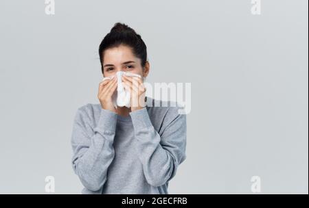 disgruntled woman runny nose cold health problems treatment Stock Photo