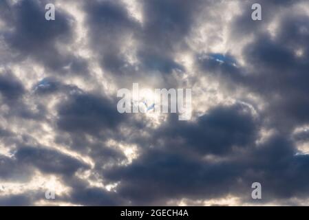 Rays of light shining throug dark clouds.Beautiful dramatic sky with sun rays.dramatic sky sun rays. Stock Photo