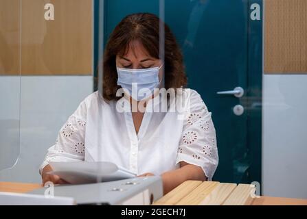 Trier, Germany. 19th Aug, 2021. Martha Schwiering, the defendant's lawyer, sits before the start of the trial in the Trier Regional Court and looks at a document. The defendant is alleged to have raced through Trier's pedestrian zone in his SUV on December 1, 2020, with the aim of killing or injuring as many people as possible. The prosecution accuses him of five counts of murder and 18 counts of attempted murder. Credit: Harald Tittel/dpa/Alamy Live News Stock Photo