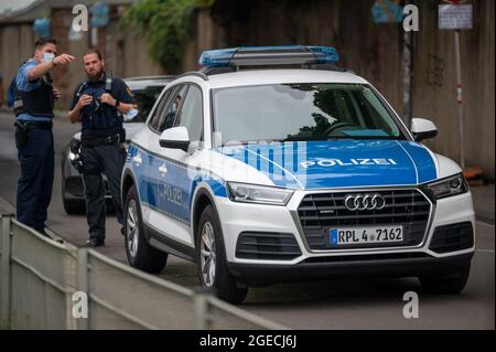 Trier, Germany. 19th Aug, 2021. Police officers stand at the start of the trial at Trier Regional Court. The defendant is alleged to have raced through Trier's pedestrian zone in his SUV on December 1, 2020, with the aim of killing or injuring as many people as possible. The prosecution accuses him of five counts of murder and 18 counts of attempted murder. Credit: Harald Tittel/dpa/Alamy Live News Stock Photo