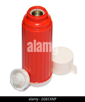Orange Thermos vacuum flask from 1960's. Keep drinks hot or cold in this glass vacuum flask with red/orange plastic casing. With screw on cup. Stock Photo
