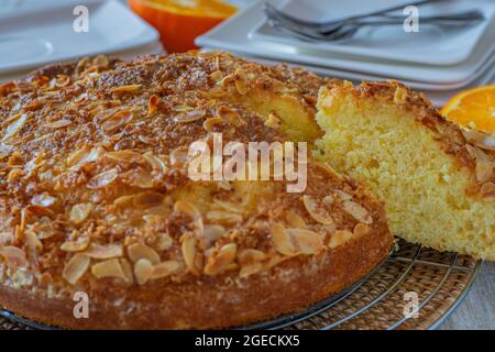 Almond orange cake served on a table. Closeup view with table background Stock Photo