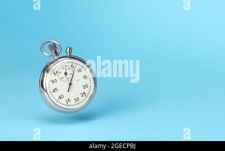 Stopwatch in levitation on blue background. Template Copy space for text. Stock Photo