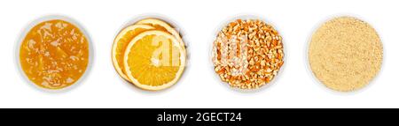 Orange jam and dried oranges, in white bowls. Marmalade, dried orange slices, chopped and powdered peel of oranges. Christmas cooking and decorations. Stock Photo