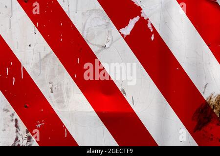 red and white diagonal stipes on flat steel sheet - caution road sign Stock Photo