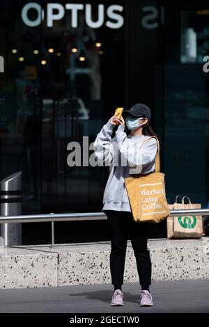 Melbourne, Australia, 9 September, 2020. A woman wearing a facemask takes photos with her phone in Bourke Street Mall during COVID-19 in Melbourne, Australia. Victoria records a further 76 cases of Coronavirus over the past 24 hours, an increase from yesterday along with 11 deaths. This comes amid news that AstraZeneca pauses vaccine study. Credit: Dave Hewison/Speed Media/Alamy Live News Stock Photo