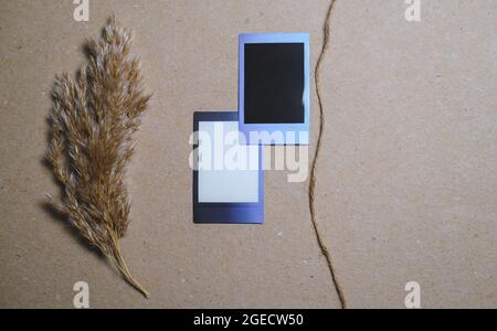 Two Vintage Photo Frames with reed and rope on brown wall. Perfect design elements, scrapbooks, memories, craft projects Stock Photo