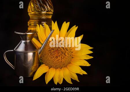Sunflower and sunflower oil still life isolated on black background Stock Photo